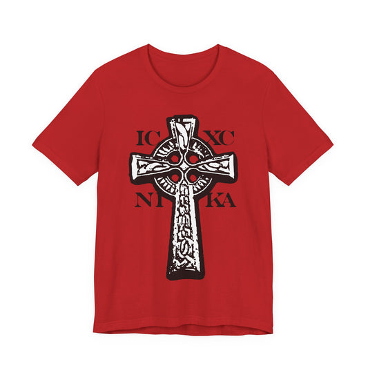 Red "ICXC NIKA Celtic Knotwork Cross" T-shirt features a bold black and white cross with "IC XC NIKA"—Jesus Christ Conquers—on a red background. Traditional Orthodox Christian design.