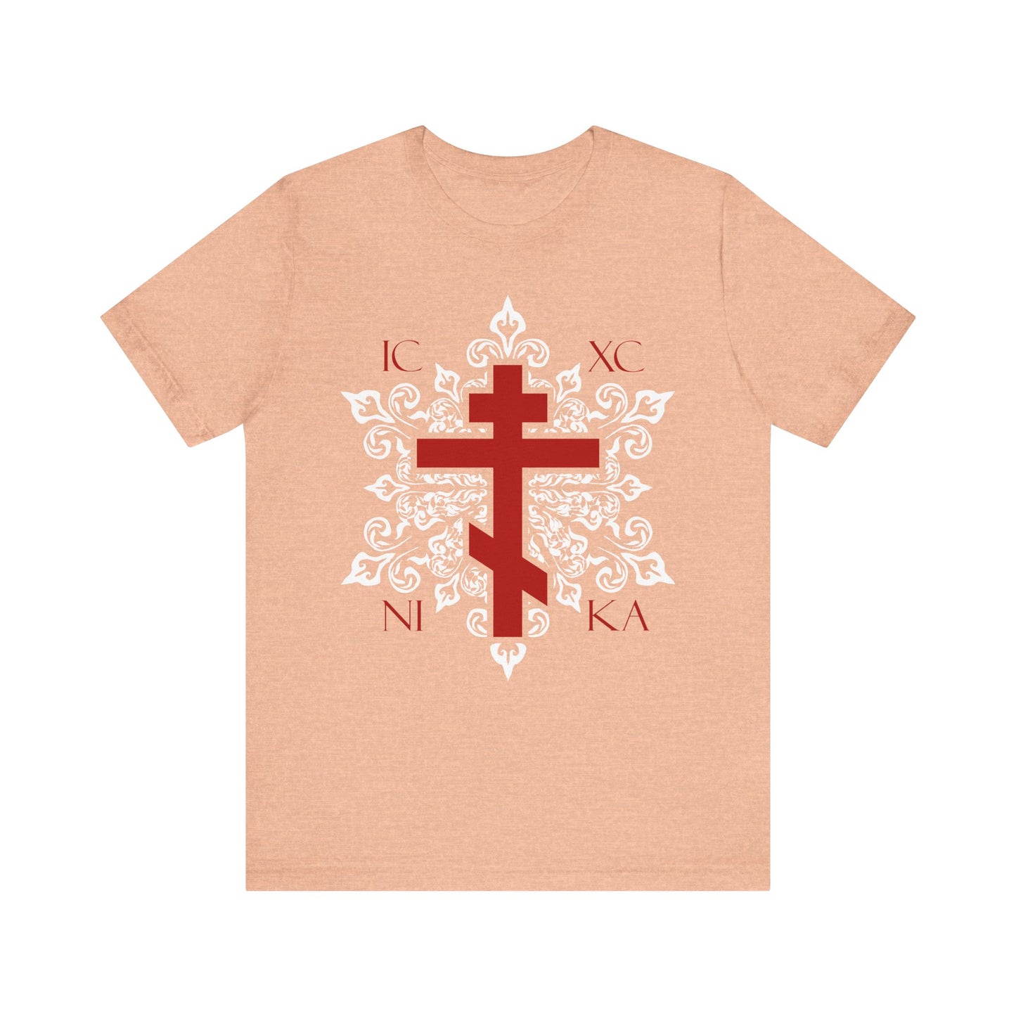 The Heather Peach unisex tee features the ICXC / NIKA red Orthodox cross on an ornate white medieval floral design—a best-selling lightweight cotton shirt inspired by Orthodox Christian tradition.