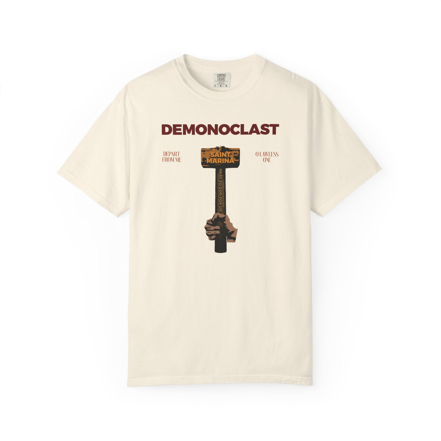 Ivory heavyweight cotton unisex tee featuring "DEMONOCLAST," St. Marina's hammer, NIKA fist, "Christ Conquers," and martyrdom motifs, inspired by Orthodox themes and unseen warfare.