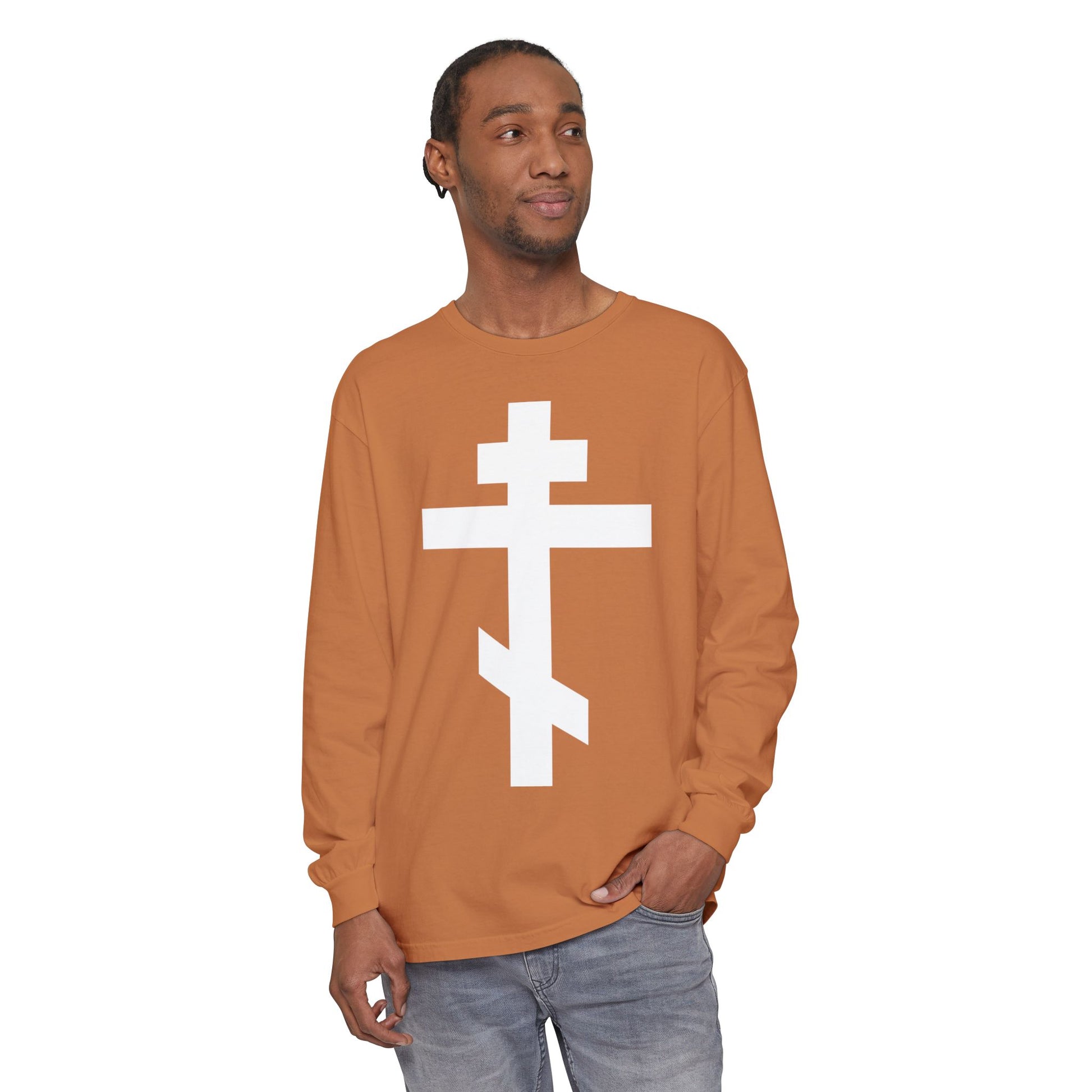 Man wearing a brown long-sleeve shirt with a large white Orthodox cross, featuring the quote "May I never boast, except in the cross of our Lord Jesus Christ" (Gal 6:14), Orthodox Long Sleeve Shirt.