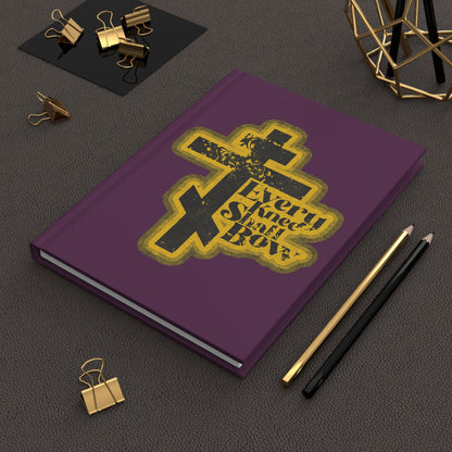 A 70s distressed halftone comic book style journal, "Every Knee Shall Bow" (Philippians 2:10-11, Isaiah 45:23), rests on a desk with pens and gold clips—a unique Orthodox Christian blank notebook.