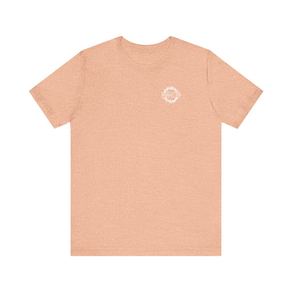 Heather peach short-sleeve tee featuring a small branded graphic on the front and large DEAD TO THIS WORLD Christian Goth flower cross & skull print on the back; inspired by The Ladder of Divine Ascent and dispassion.