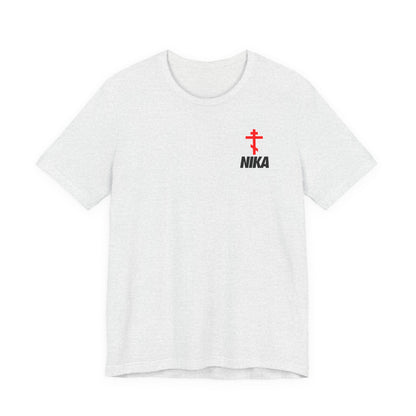 Ash-colored t-shirt featuring an Orthodox cross with bold NIKA text, inspired by the NIKE logo and the phrase "Jesus Christ Conquers," in a small design on the left chest.