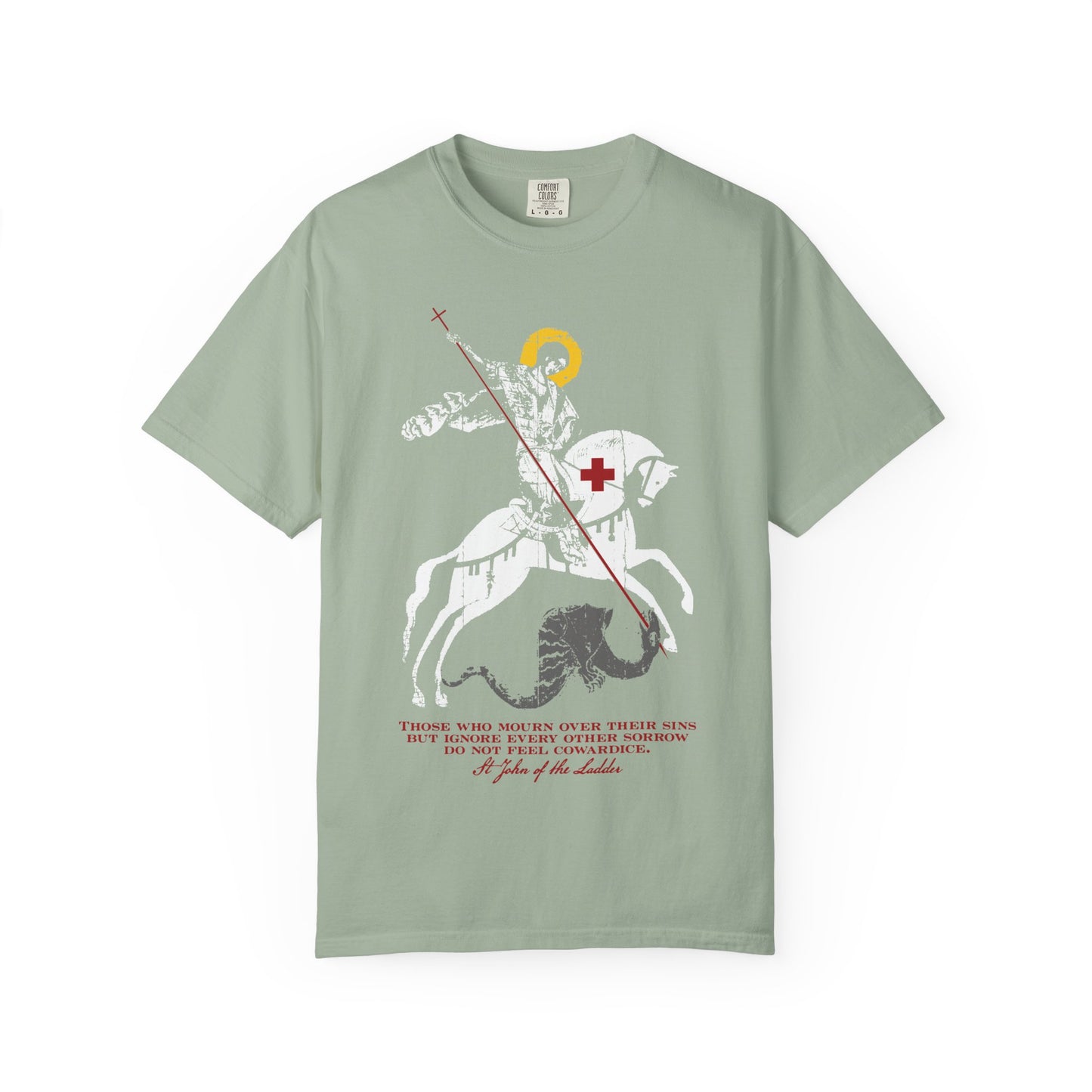 Bay-colored heavyweight cotton unisex tee titled “Those Who Mourn Over Their Sins,” featuring an iconographic design of St. George slaying the dragon with a quote inspired by St John Climacus on the sadness of soul printed in red and white beneath the image.