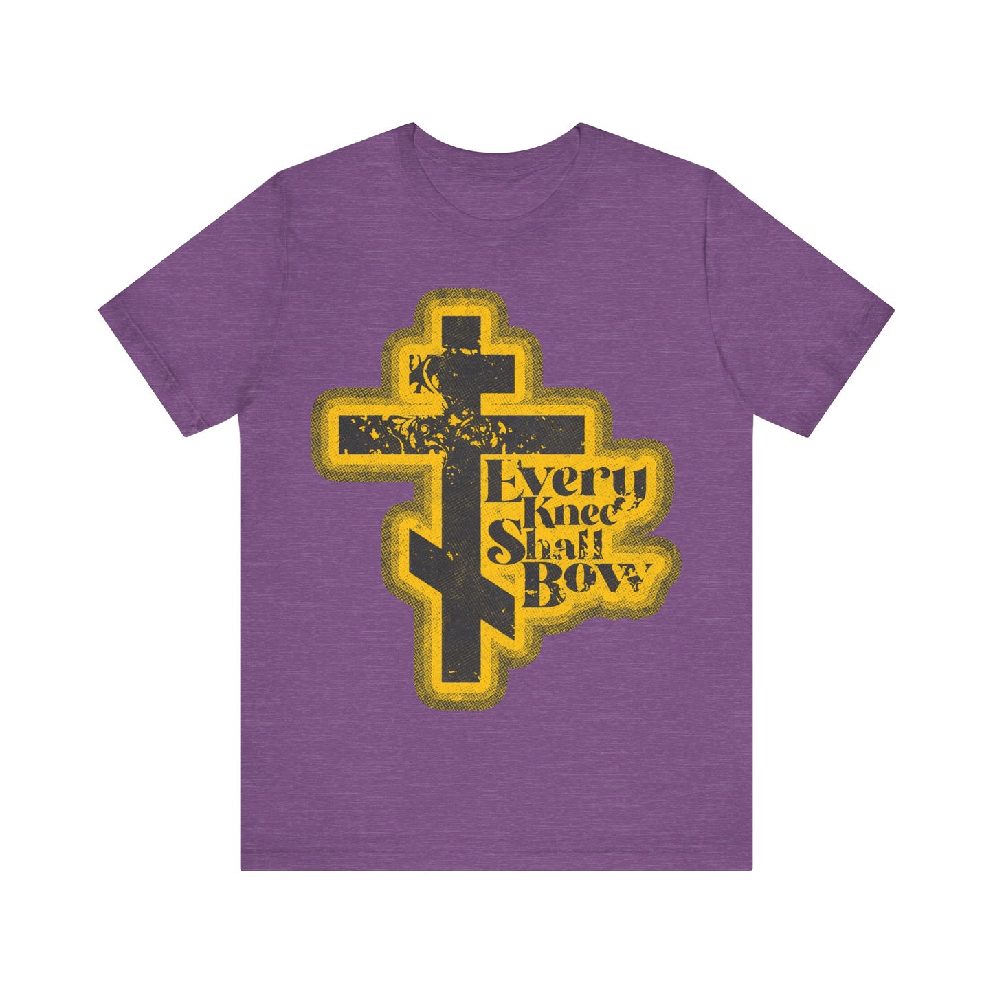 Heather Team Purple t-shirt featuring a yellow and black Orthodox cross with "Every Knee Shall Bow," inspired by Philippians 2:10-11 and Isaiah 45:23, in a 70s distressed halftone comic book style.