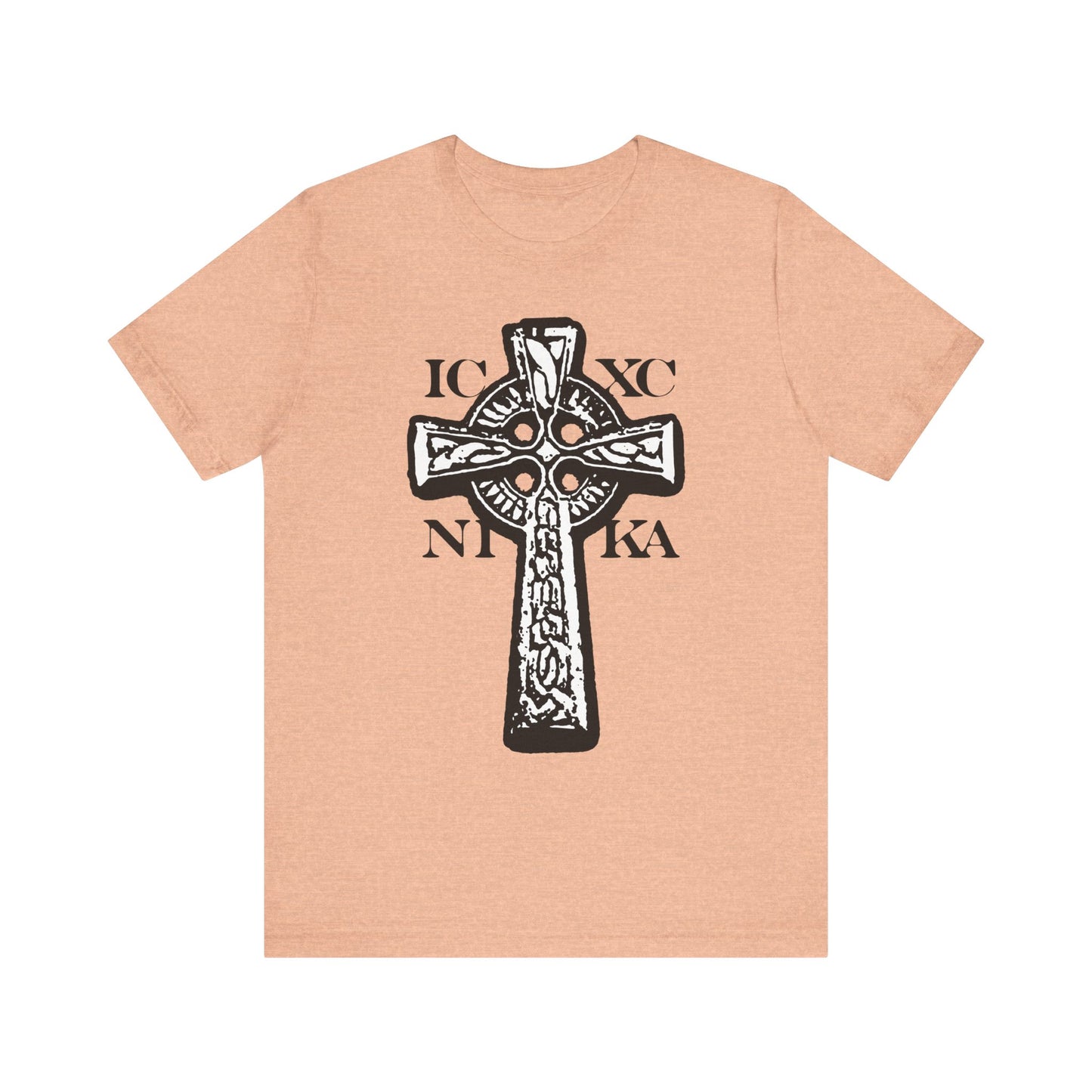 Heather peach t-shirt featuring a black-and-white ICXC NIKA Celtic knotwork cross on a red background, symbolizing "Jesus Christ Conquers." This lightweight cotton unisex shirt displays the power and victory of the Lamb of God.