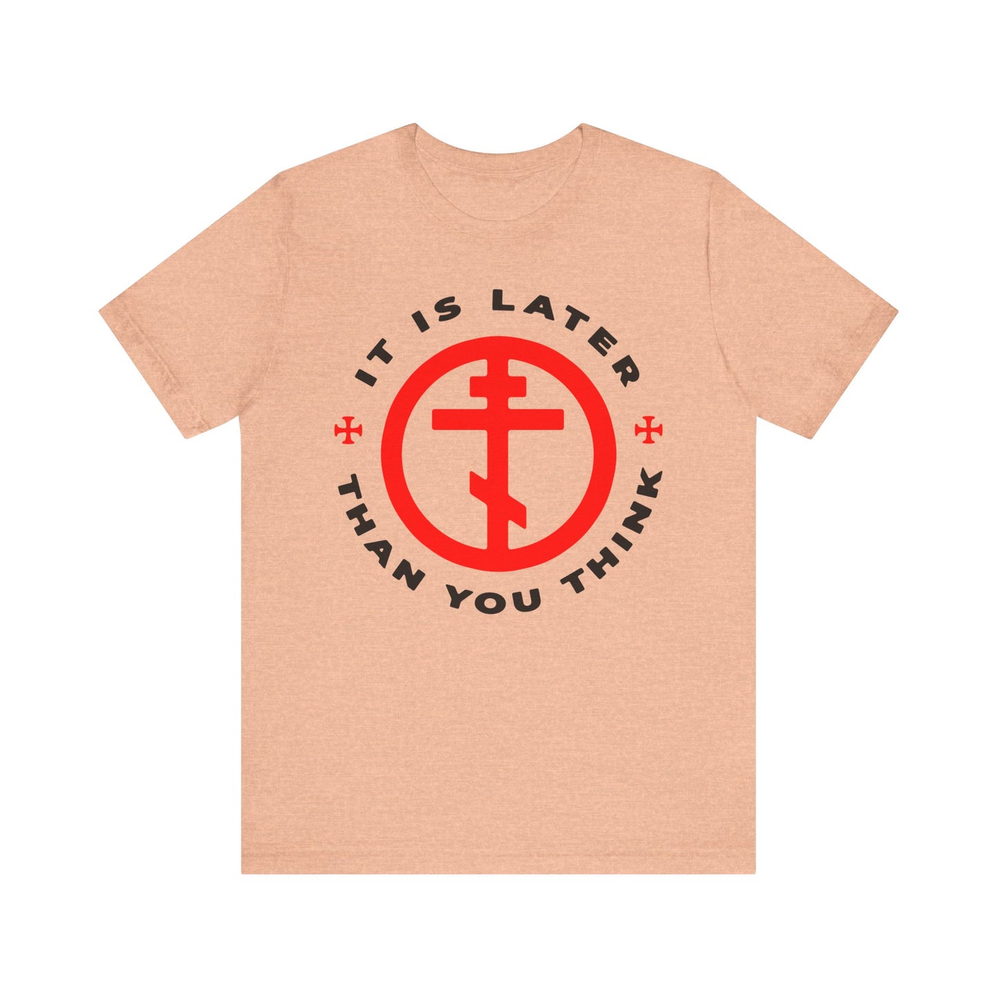 Heather peach t-shirt featuring a red symbol in a circle and black text reading "It is later than you think"—a subtle tribute to Fr. Seraphim Rose, the American Orthodox saint known for his memento mori teachings reminding us to cast off darkness and put on the armour of light. This lightweight cotton unisex tee blends comfort with apocalyptic wisdom.