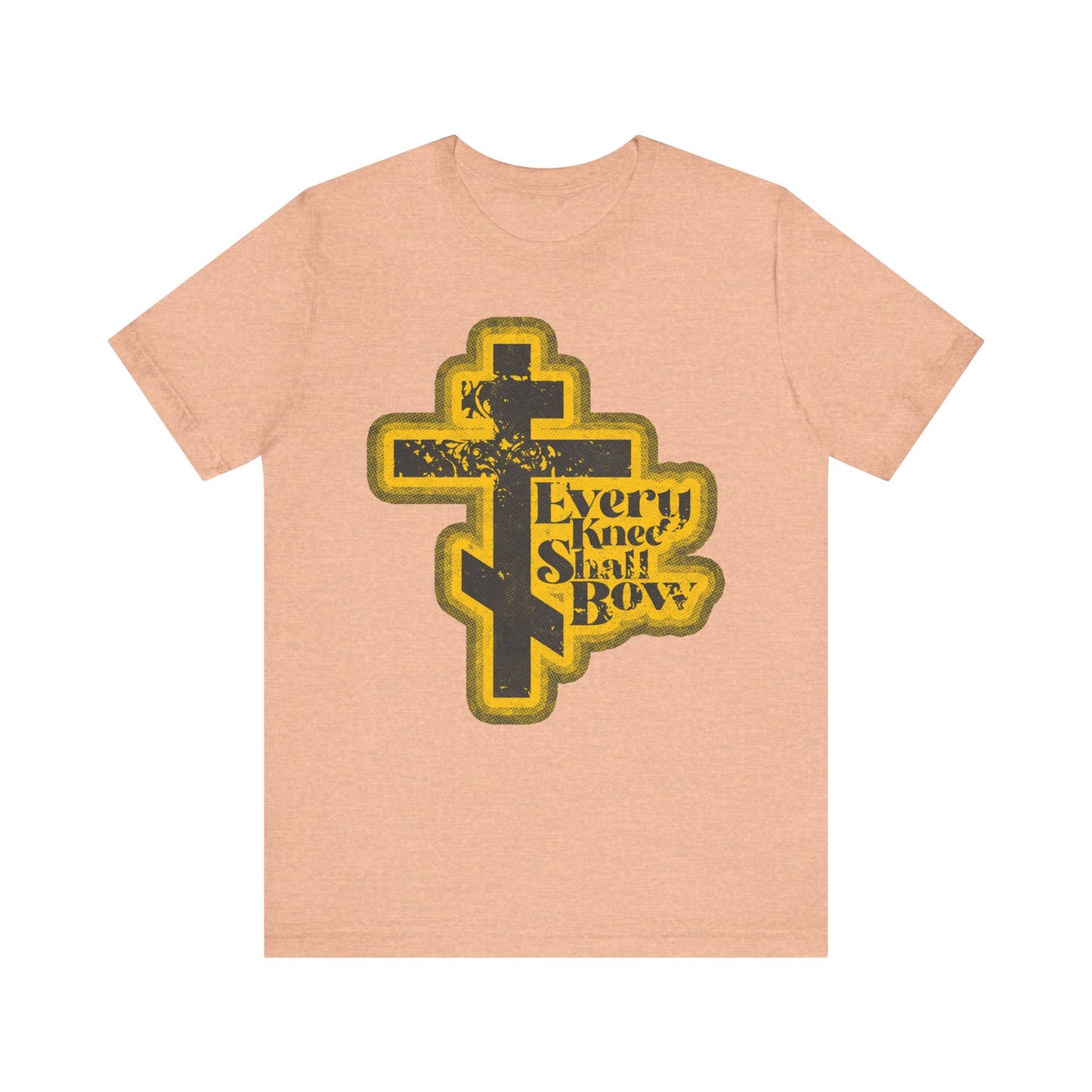 Heather peach unisex tee featuring a yellow and black cross with "Every knee shall bow" on the front, inspired by Philippians 2:10-11 and Isaiah 45:23 in a 70s distressed comic book style. Lightweight cotton.