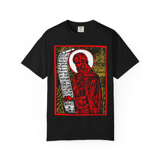 The "St. John of Damascus Icono-Graphic" black heavyweight cotton tee features a bold red and gold Orthodox saint design inspired by funeral hymns, with high contrast graphics and text scroll. Unisex fit.
