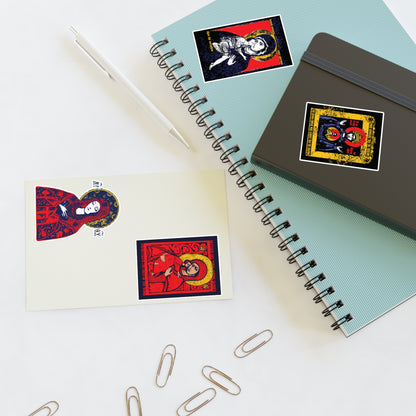 Two spiral notebooks, a pen, and three paper clips sit on a white surface. Each notebook and a postcard feature Remembrance of Death Theotokos IconoGraphic Sticker Collection No. 1 with vibrant Orthodox designs like the Vladimir Icon.