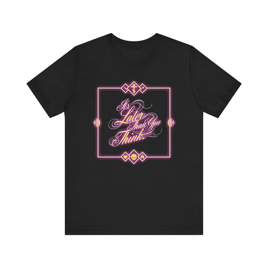 Black unisex t-shirt featuring glowing neon cursive typography reading "It's Later Than You Think"—inspired by Fr. Seraphim Rose—a subtle nod to memento mori and the weight of our eternal fate, all framed by luminous neon-style designs on lightweight cotton.