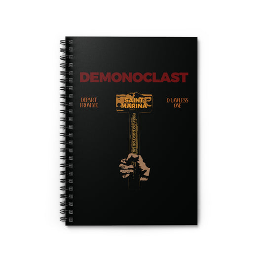 Black spiral notebook featuring "Demonoclast | St. Marina's Hammer | NIKA Fist | Christ Conquers | Demon Smasher | Unseen Warfare | Christian Martyrdom" design with a hand holding a golden hammer, inspired by the Life of St. Marina.