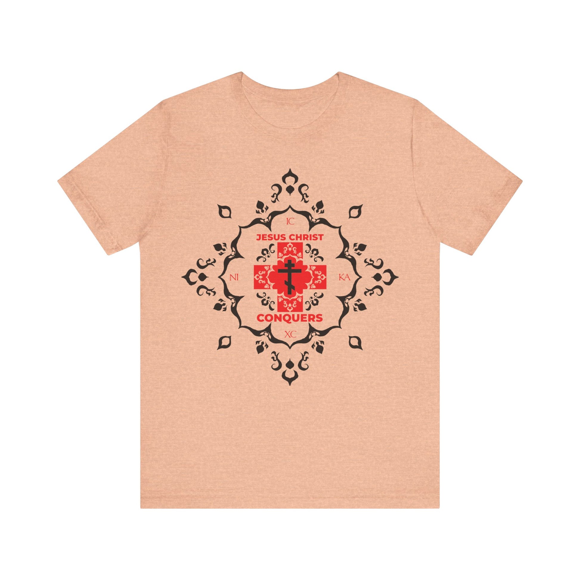 Heather peach t-shirt featuring a white Orthodox cross with "ICXC NIKA" in red modern font and medieval filigree, symbolizing Jesus Christ's victory—echoing St. John Chrysostom. 100% cotton Christian tee.
