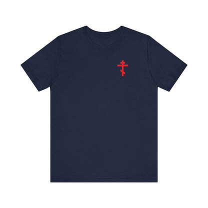 Navy ICXC NIKA t-shirt featuring a small red Orthodox cross on the front left chest and a white medieval floral design, displayed on a white background. This lightweight cotton unisex shirt is available for custom order.