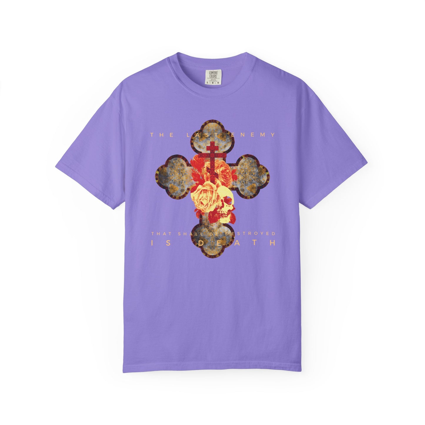 Violet heavyweight cotton t-shirt featuring a metallic gothic cross, rose, and skull graphic with the text “The Final Enemy That Shall Be Destroyed Is Death” (1 Cor 15:26). Unisex fit; celebrates resurrection.