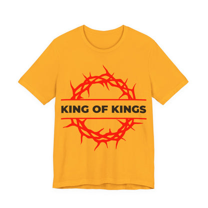 Gold unisex cotton tee featuring a red crown of thorns and "KING OF KINGS" in bold black letters, inspired by Revelation 19:16 and Christ the victorious King. Orthodox Christian design: King of Kings Crown of Thorns | The King of Glory.