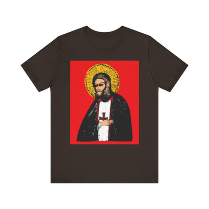 Brown unisex tee with St Seraphim of Sarov iconography—features a stylized saint holding a cross on red, symbolizing the true aim of Christian life: the acquisition of the Holy Spirit. Lightweight, 2-sided cotton design.
