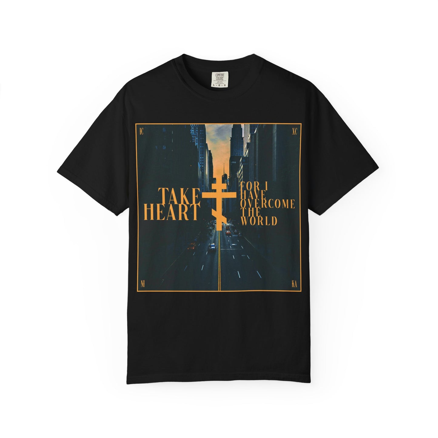 Black heavyweight cotton unisex tee featuring a modern city street scene and the gold-printed words "Take Heart, For I Have Overcome the World" (John 16:33)—a wearable reminder that though spoken in parables, your sorrow will turn to joy when you ask and receive.