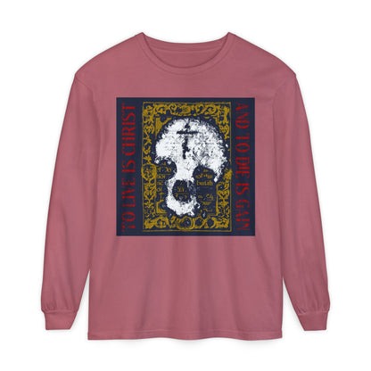 Crimson long sleeve shirt featuring a skull with cross on gold manuscript texture and "To Live is Christ, to Die is Gain (Philippians 1:21)"—a bold Orthodox Christian reminder that Christ shapes your life.