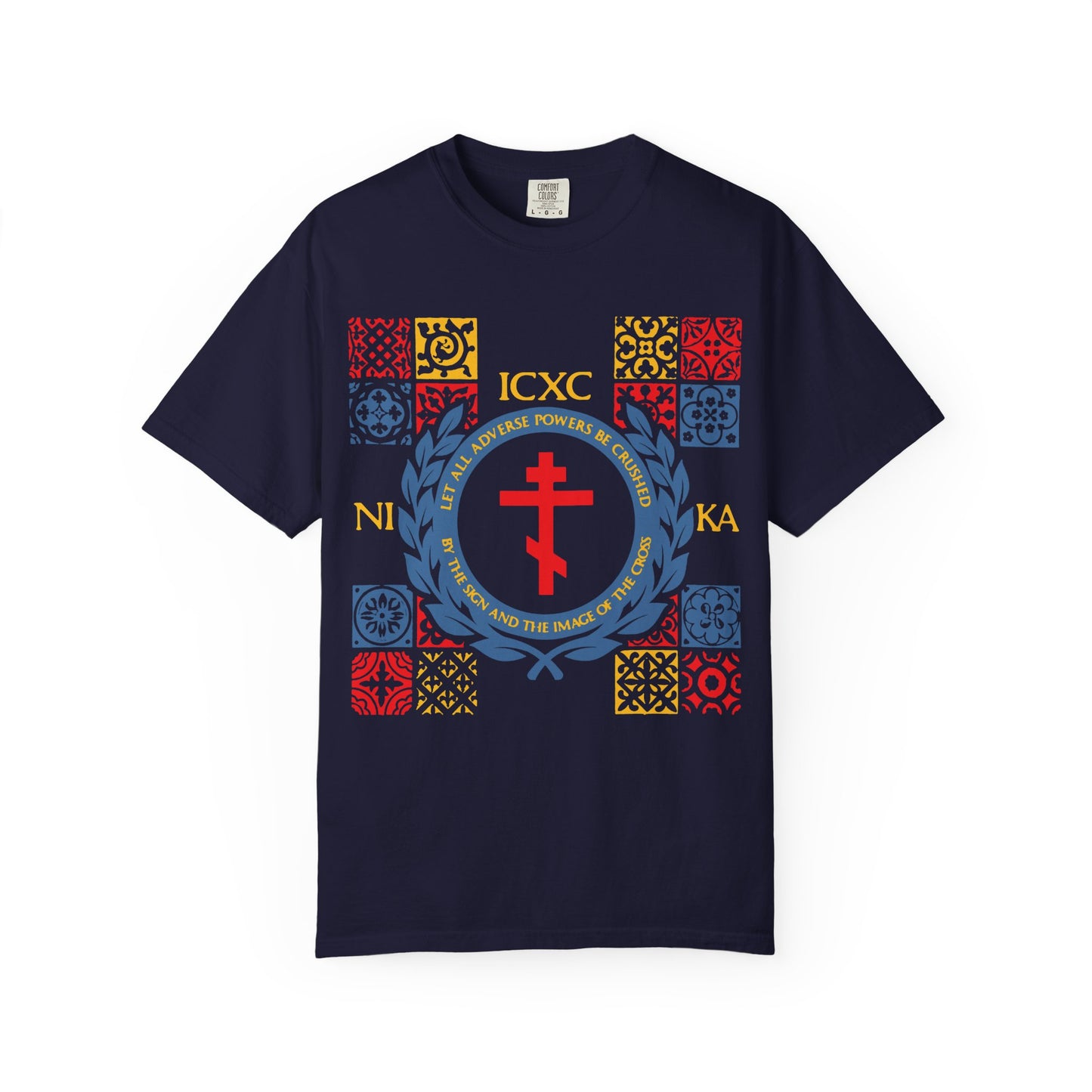 True Navy heavyweight cotton unisex T-shirt titled "Let All Adverse Powers Be Crushed (Red, Yellow & Blue Design) | ICXC NIKA," featuring a medieval tile motif with colorful squares, a red cross reminiscent of the Cross at the Red Sea, Greek lettering, and Christian text including a reference to Katavasia on the front.