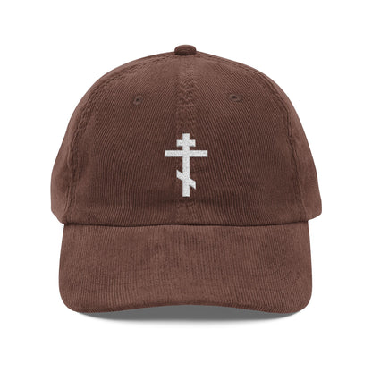 Brown cotton corduroy cap featuring a simple white Orthodox TriBar Cross, the weapon of unseen warfare which makes demons tremble. Orthodox Christian embroidered design.