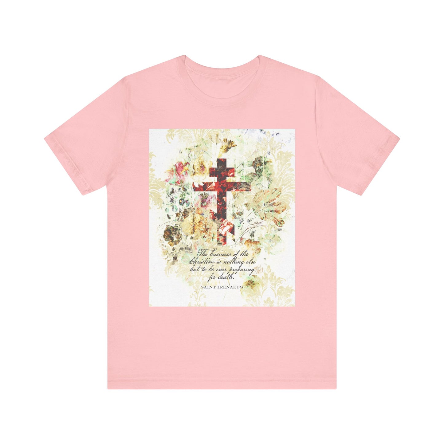 A pink lightweight cotton unisex tee featuring a white and beige floral scrapbook texture cross in arts & crafts style with a quote inspired by St. Irenaeus, surrounded by pastel flowers and leaves—an uplifting Christian reminder to prepare for death.