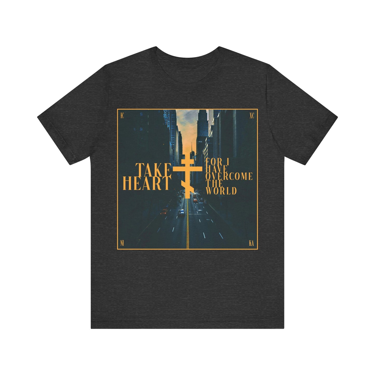 Dark Grey Heather cotton t-shirt featuring a modern city street scene and yellow "Take Heart, for I have overcome the world" (John 16:33) text—an Orthodox Christian reminder that sorrow can turn to joy.