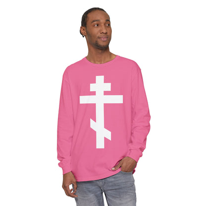Man in a pink Orthodox Long Sleeve Shirt featuring a large white cross and the quote “May I never boast, except in the cross of our Lord Jesus Christ” (Gal 6:14), standing and smiling.