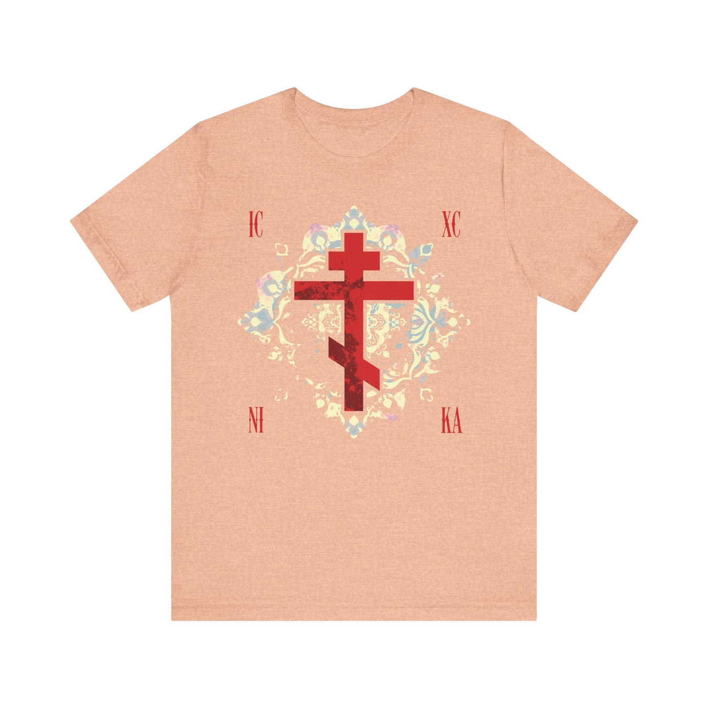 Heather Peach unisex tee featuring a textured red Orthodox cross and medieval floral background, inspired by ICXC NIKA—Jesus Christ Conquers. Lightweight cotton, celebrates Orthodox faith and spiritual endurance.