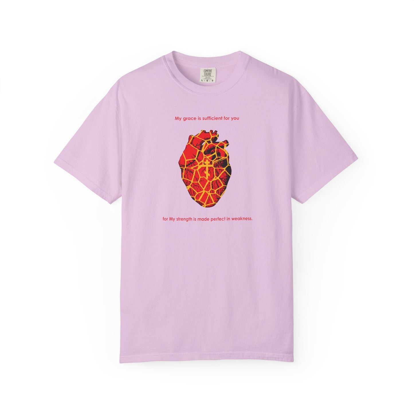 Orchid-colored heavyweight cotton tee featuring a golden Kintsugi-style broken heart with an Orthodox cross, inspired by 2 Corinthians 12:9, and text celebrating the beauty of grace and strength made perfect in weakness.
