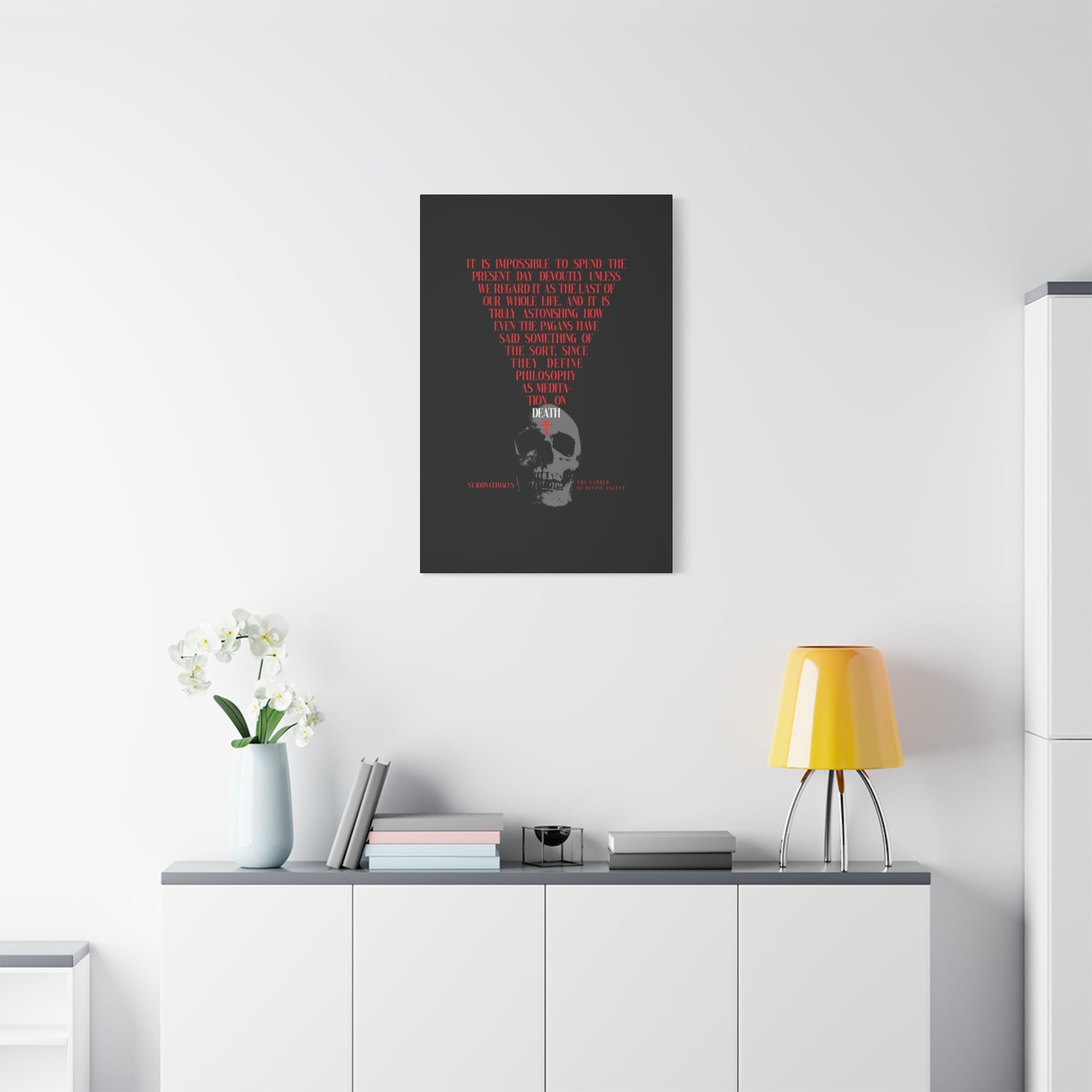A minimalist room features "The Present Day As the Last Day of Our Life" canvas—a skull with a red Orthodox cross—by St John Climacus, offering subtle memento mori décor perfect for mindful meditation and spiritual reflection.