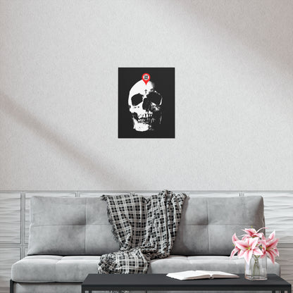 A "You Will Be Here Maps Marker on Skull" Orthodox Christian art poster hangs above a gray sofa; flowers and a book rest on the coffee table, evoking memento mori and reflection on mortality.