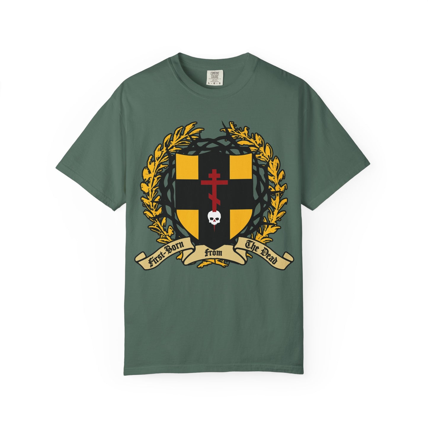 Blue Spruce heavyweight cotton unisex t-shirt featuring “First-Born from the Dead (Col 1:18)”: an Orthodox Cross piercing a skull, heraldic shield with crown of thorns, and yellow laurel—an eye-catching design inspired by Colossians 1:18 and Christ’s victory over death.