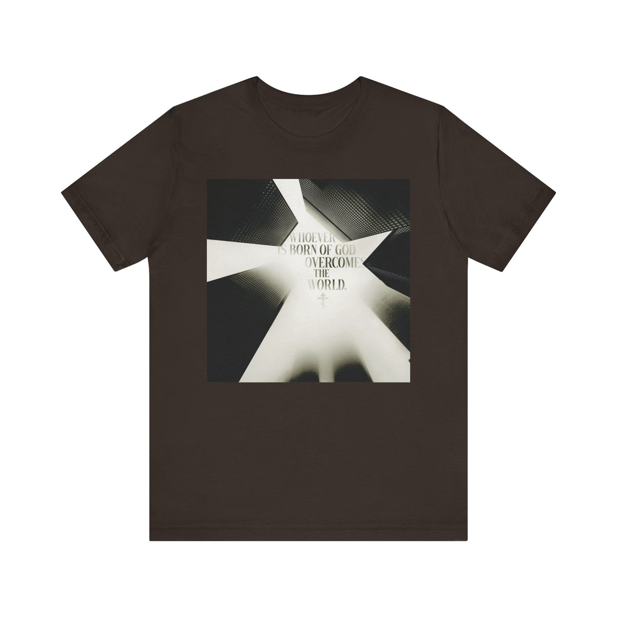 Brown unisex t-shirt featuring a modern cityscape and the message “Whoever is Born of God Overcomes the World,” inspired by St. John the Theologian (1 John 5:1–4), proclaiming that Jesus is the Christ—Orthodox Christian lightweight cotton design.