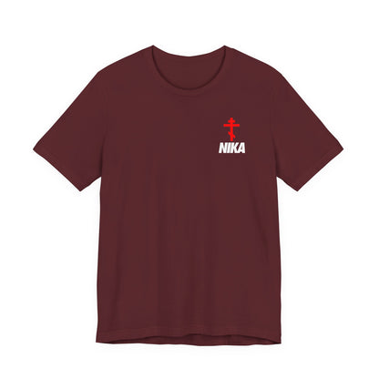 Maroon t-shirt with an Orthodox Cross and bold NIKA text in a small design, inspired by the NIKE logo. Features "Jesus Christ Conquers" theme—athletic ascetic Christian fashion.