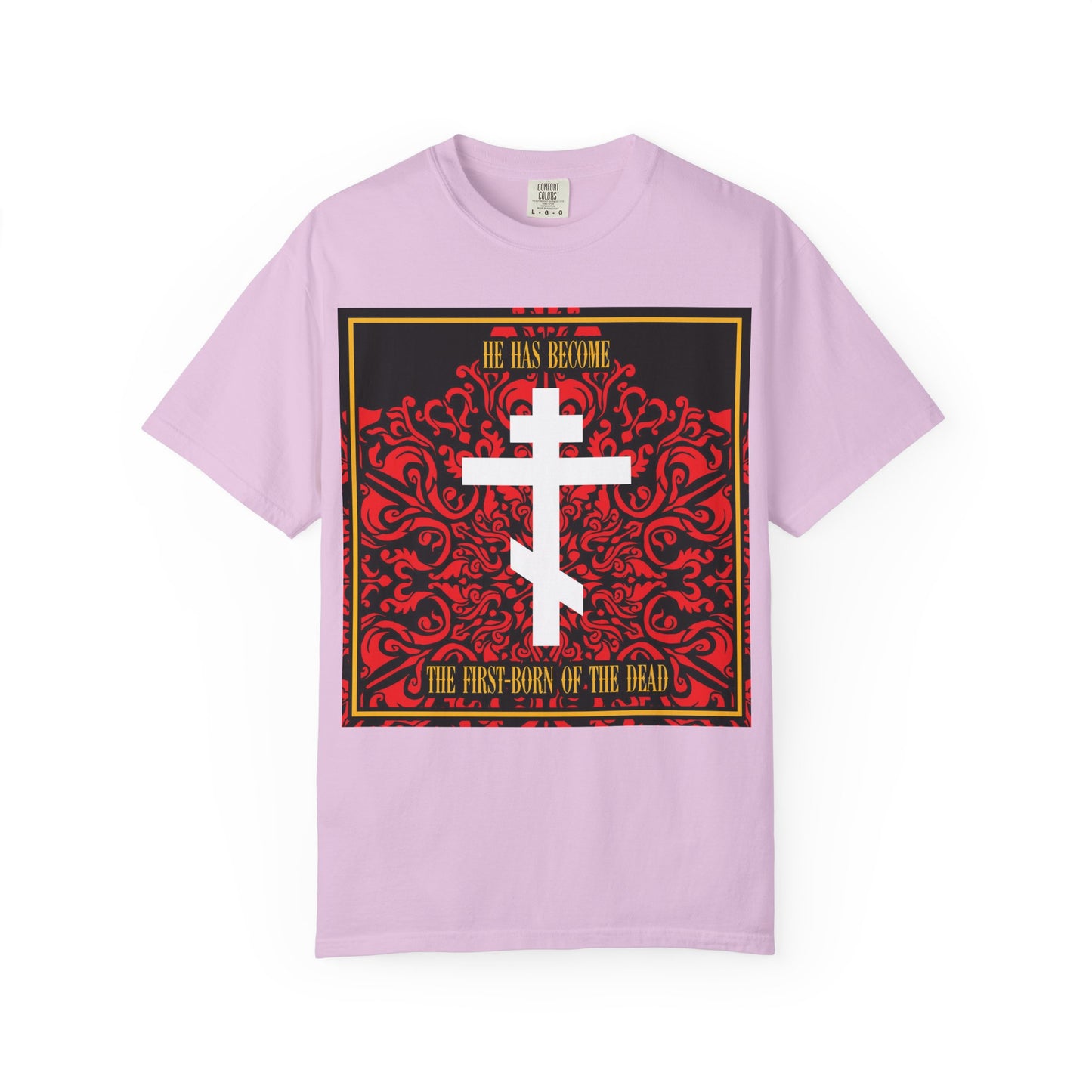 Orchid unisex heavyweight cotton tee featuring a white Orthodox cross over a red floral texture with the text "He has become the first-born of the dead." This comfortable shirt is perfect for sharing your faith in style with its subtle Bible verse design.