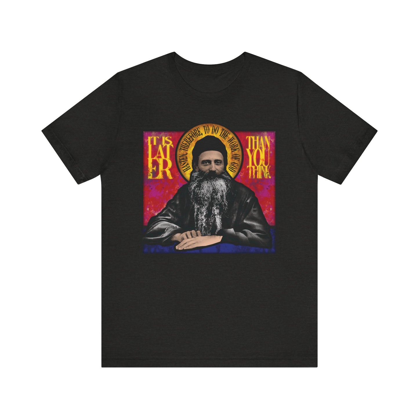 Black Heather t-shirt featuring a stained glass design of Fr. Seraphim Rose and the phrase "It is later than you think"—a tribute to the American Orthodox monastic saint and a reminder of life's urgency. Lightweight cotton, unisex fit.