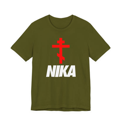 Olive T-shirt with a red Orthodox cross above bold white NIKA text, inspired by the NIKE logo. Minimalist Christian design: Jesus Christ Conquers. Athletic Ascetic fashion.