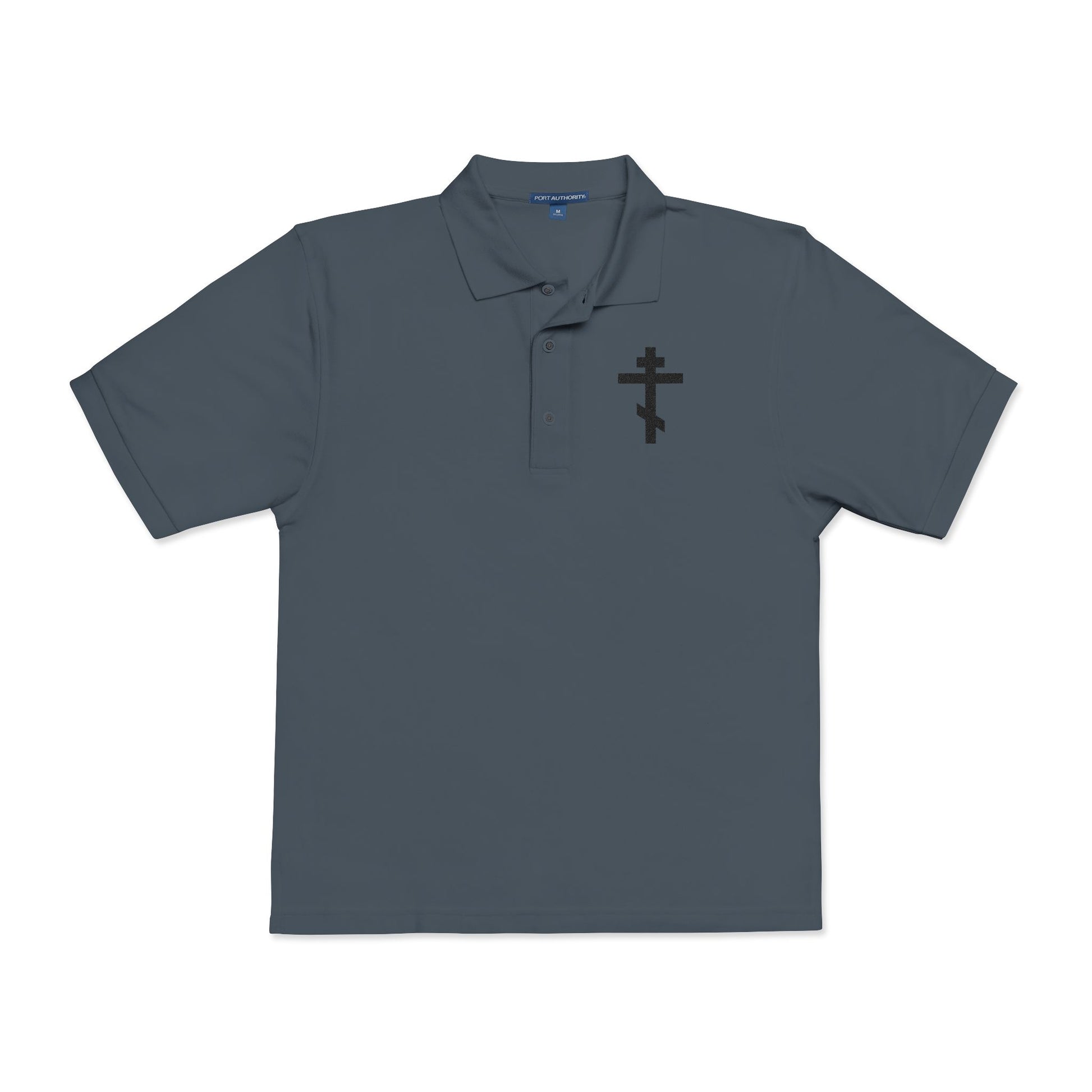 Steel grey short-sleeve polo featuring an embroidered black Orthodox cross and the quote: "May I never boast, except in the cross of our Lord Jesus Christ" (Gal 6:14). Christian-inspired design.