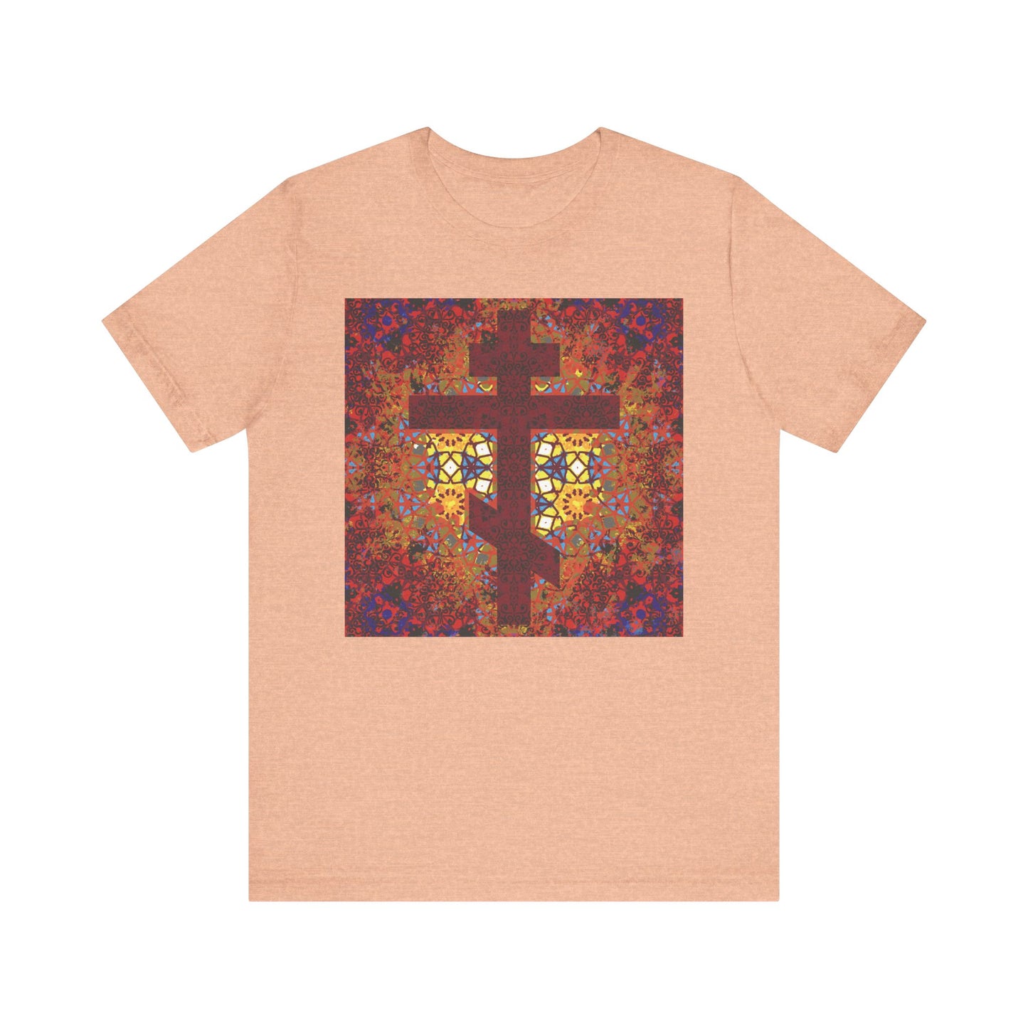 Heather peach unisex Christian t-shirt made of lightweight cotton, featuring a geometrical stained glass Orthodox cross design in red, yellow, and purple with an inspirational quote from Elder Ambrose of Optina.