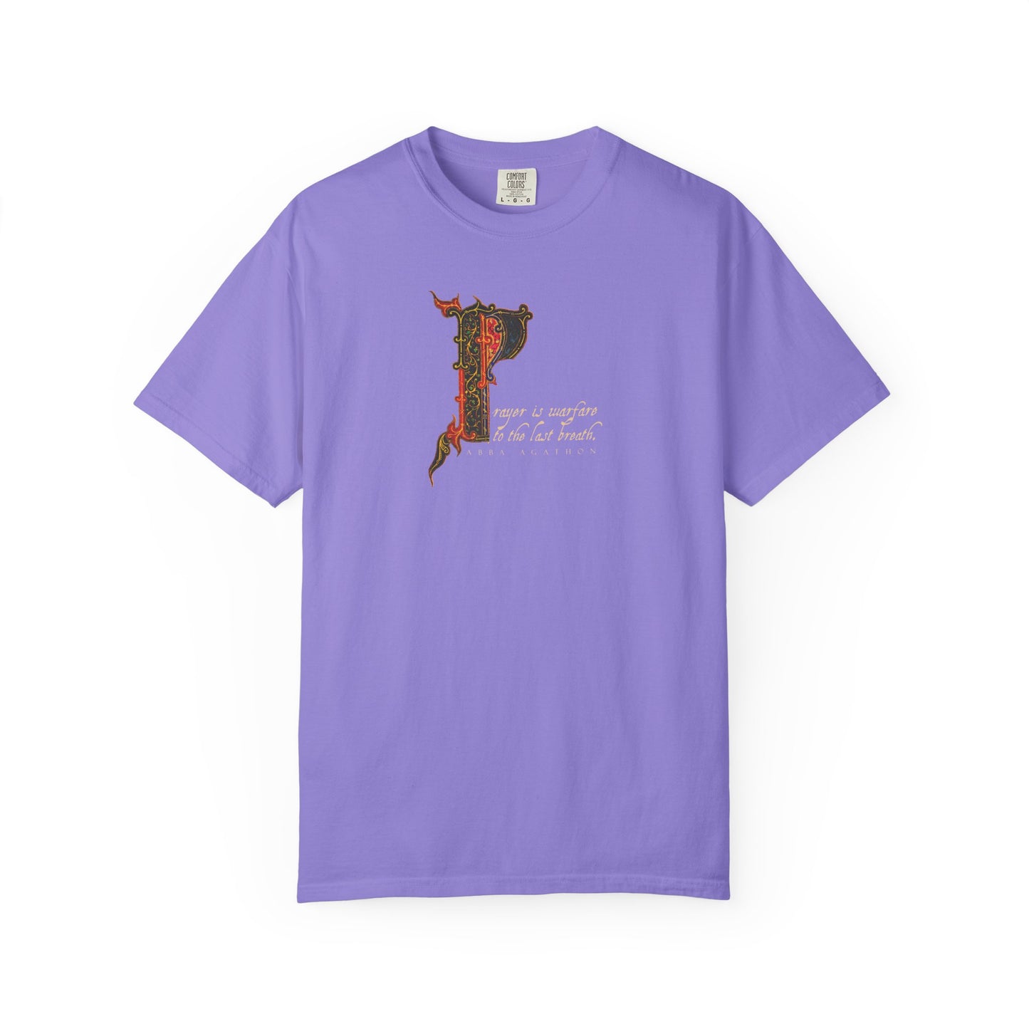 Violet heavyweight cotton unisex tee titled "Prayer is Warfare to the Last Breath - Abba Agathon | Desert Fathers | Illuminated Manuscript," adorned with an ornate letter P and cursive text inspired by Abba Agathon’s teachings on prayer and spiritual warfare, shown on a white background.