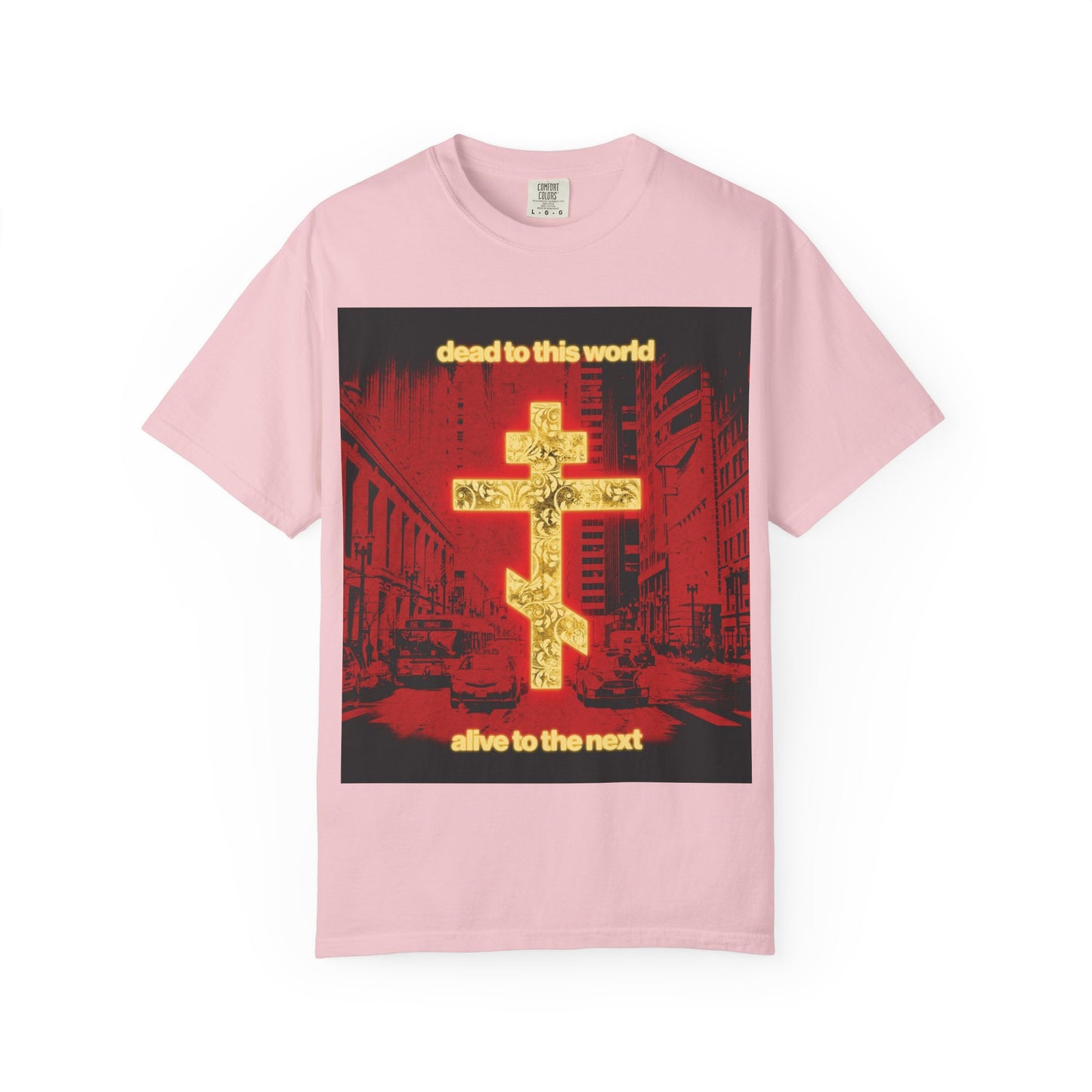 Blossom-colored “Dead to This World Alive to the Next” heavyweight cotton unisex tee, featuring a glowing gold cross graphic over a vivid red cityscape background with the text “dead to this world, alive to the next”—a bold Orthodox Christian statement inspired by St Ignatius.