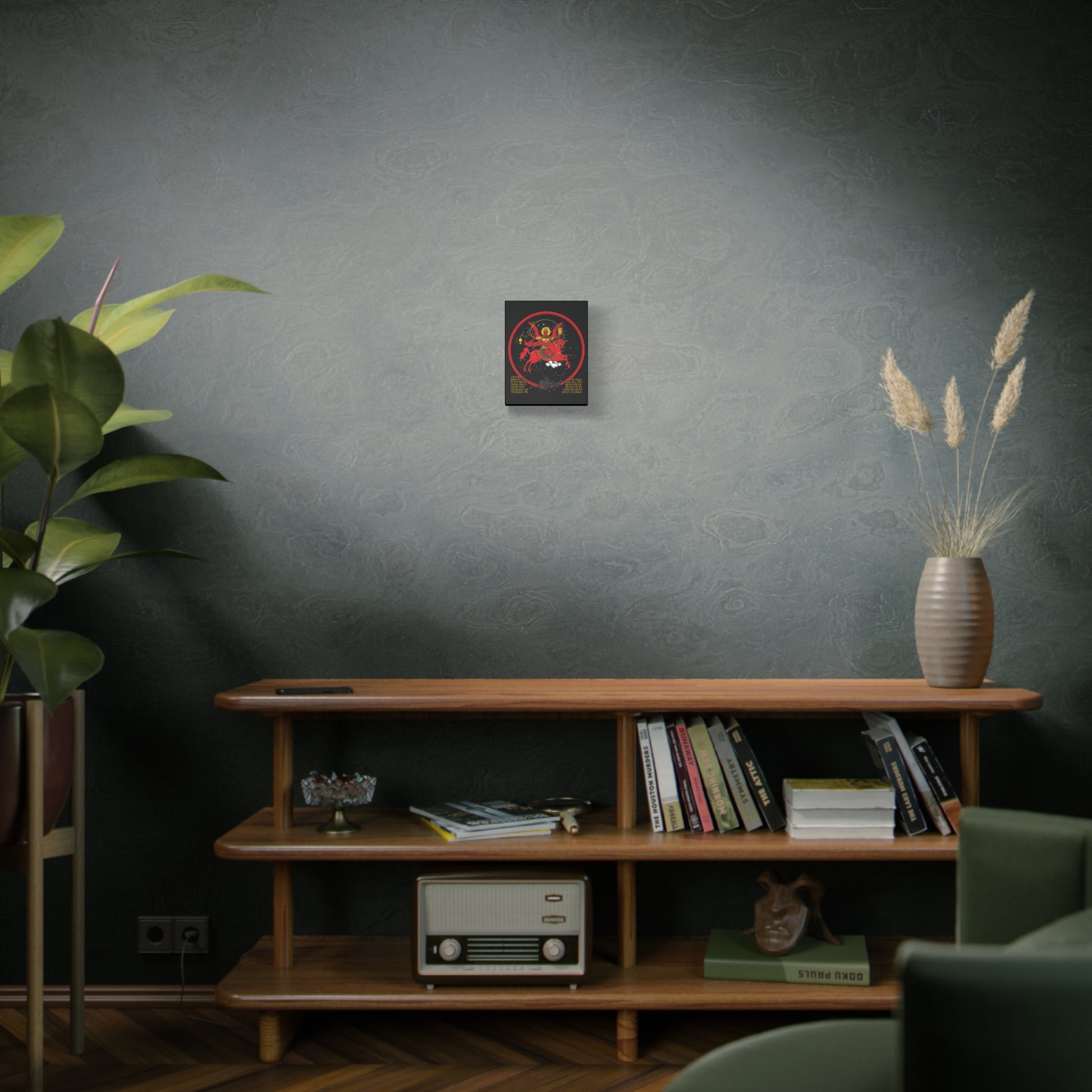 A cozy, modern living room with a wooden shelf, books, vintage radio, plants, and wall art featuring the "Archangel Michael of the Apocalypse Icono-Graphic | War in Heaven (Rev 12:7-9) | Christian Canvas Art.
