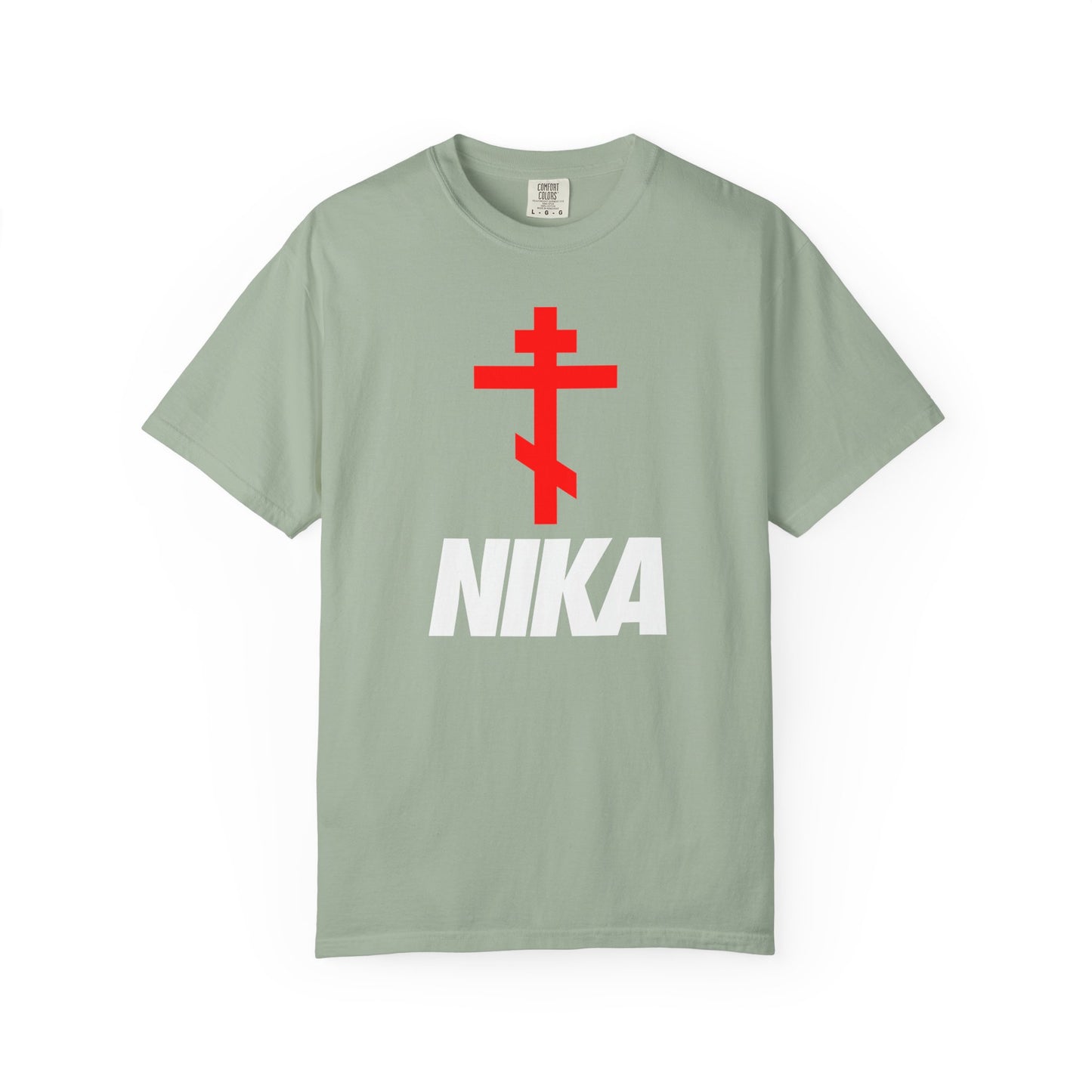 Bay-colored heavyweight unisex tee with a red Orthodox cross above bold white NIKA text, styled as a NIKE logo mashup. Minimalist athletic-ascetic design inspired by Revelation 3:21’s message of victory in Christ.