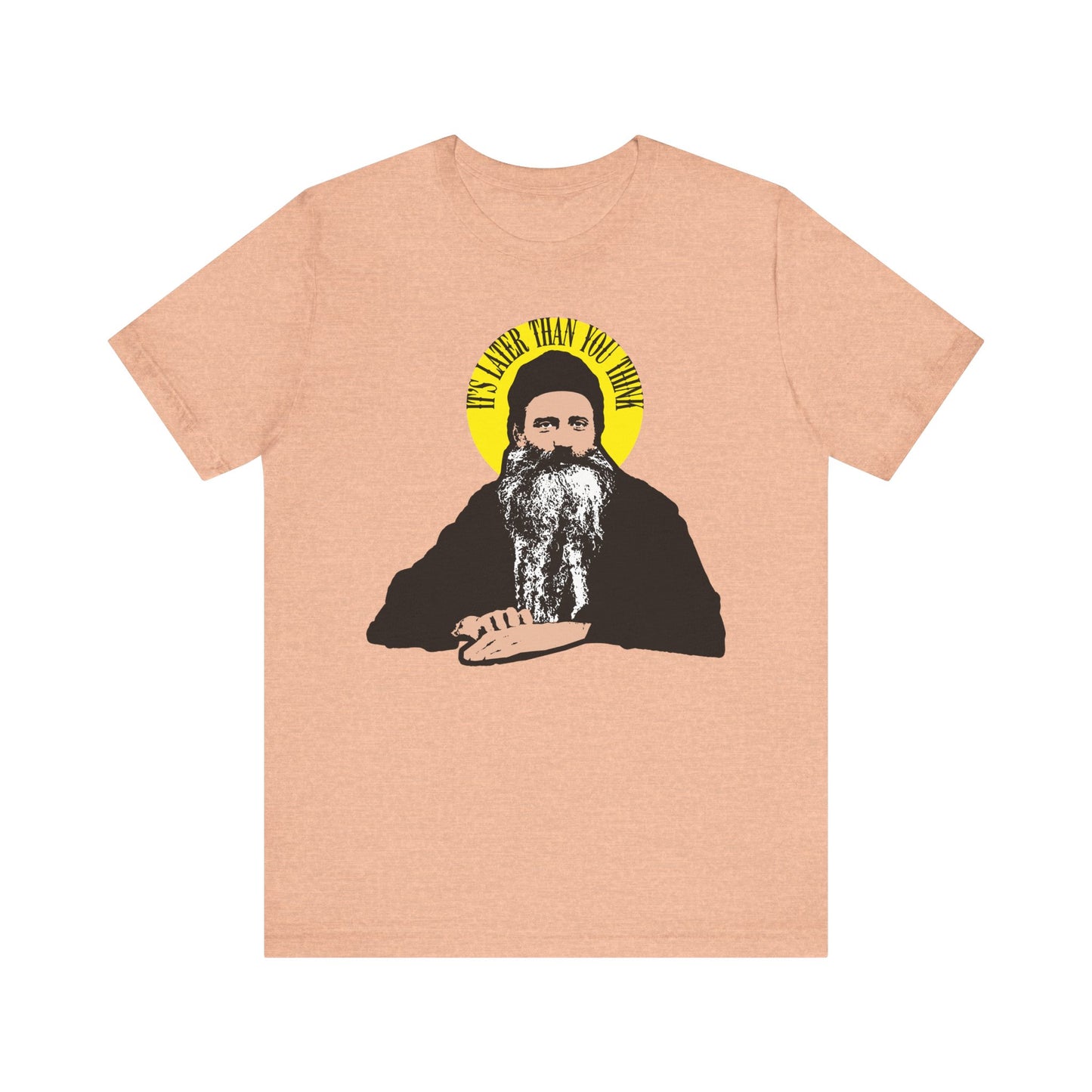 Heather Peach unisex tee featuring "It's Later Than You Think" in a yellow halo—a quote from St. Seraphim Rose—on lightweight cotton; a modern American Orthodox saint's reminder to all.