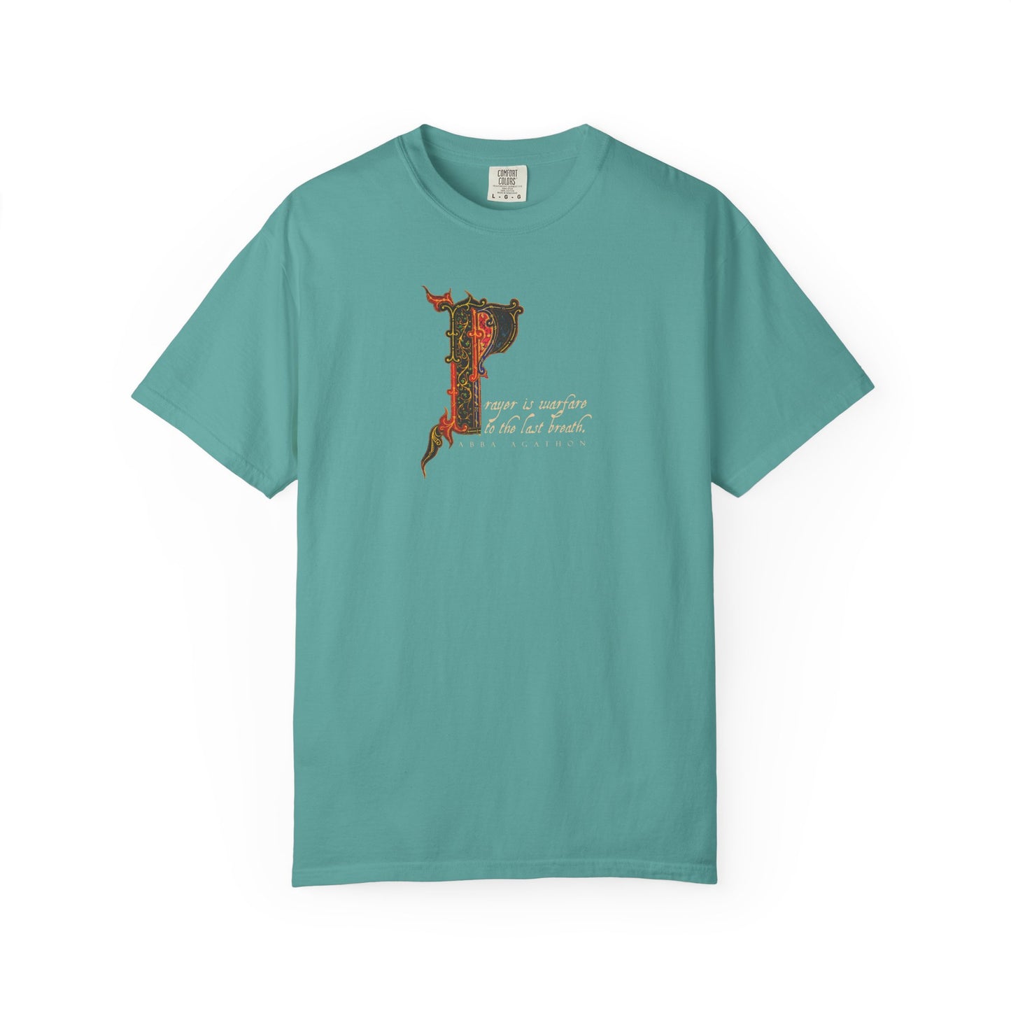 Seafoam heavyweight cotton unisex tee featuring an ornate letter P and illuminated manuscript-inspired decorative text on the front, drawing on the wisdom of Abba Agathon and the theme "Prayer is Warfare to the Last Breath" from the Desert Fathers, displayed on a white background.