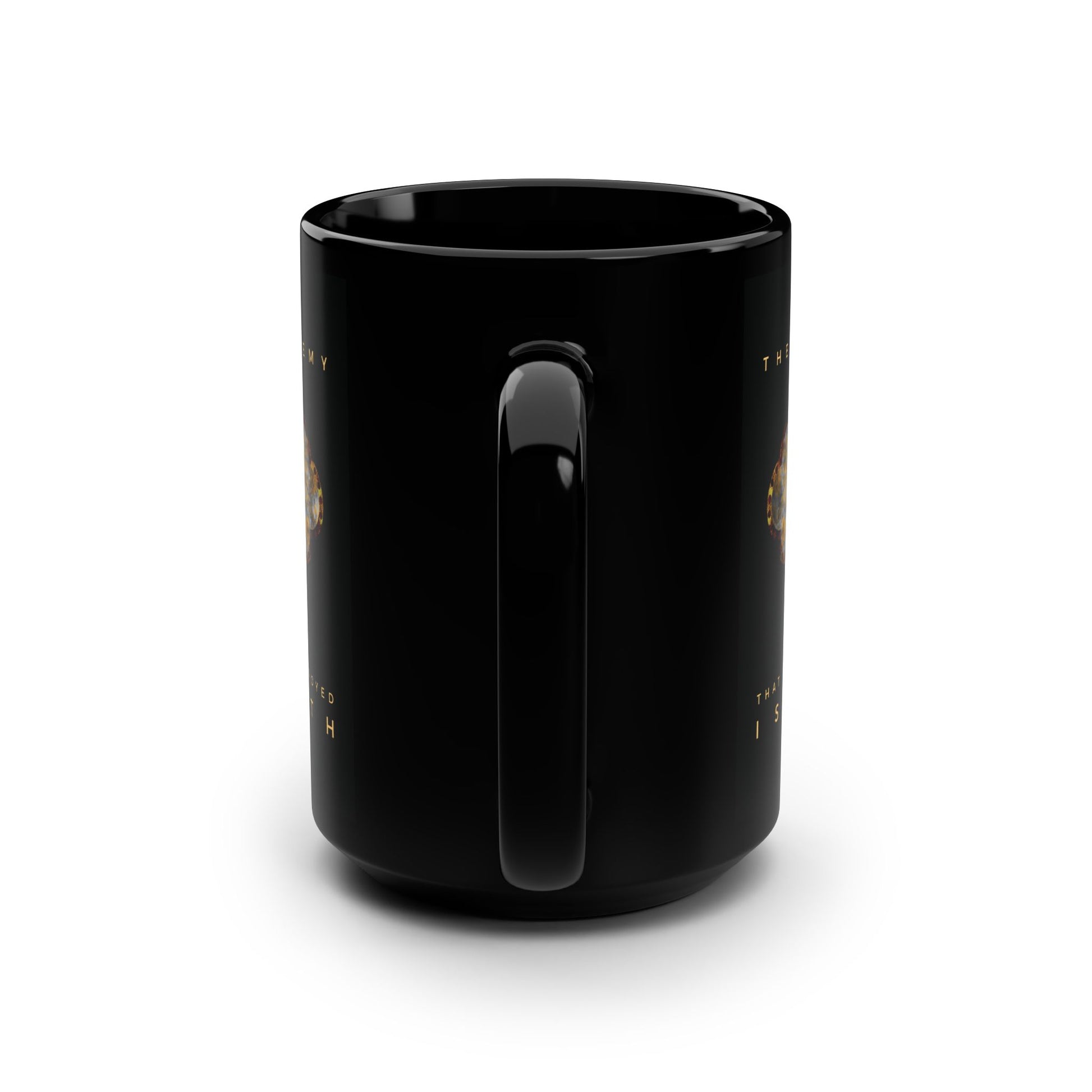 A glossy black ceramic Remembrance of Death mug is shown from the back with its handle centered. Faint gold text from 1 Cor 15:26 and a metallic gothic cross with rose and skull are partially visible on both sides. The background is white.