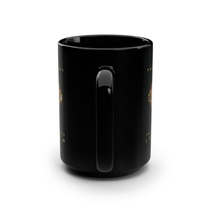 A glossy black ceramic Remembrance of Death mug is shown from the back with its handle centered. Faint gold text from 1 Cor 15:26 and a metallic gothic cross with rose and skull are partially visible on both sides. The background is white.