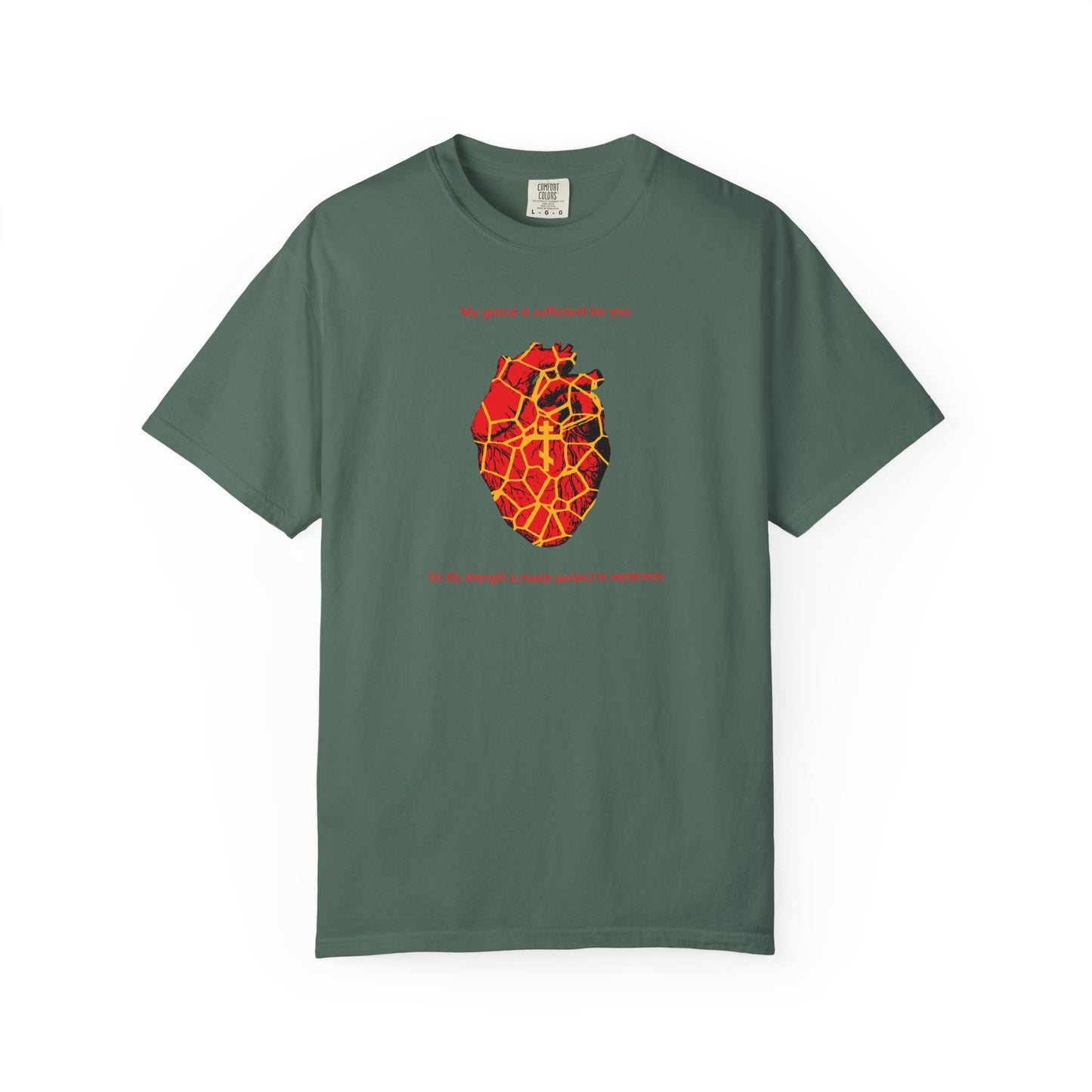 Blue spruce T-shirt featuring a golden, Kintsugi-style broken heart illustration with an Orthodox cross and subtle text above and below the heart, expressing how strength is made perfect in weakness as inspired by 2 Corinthians 12:9.