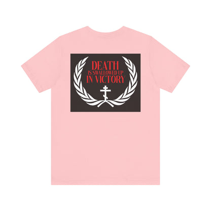 The Archangel Michael of the Apocalypse Iconographic / Death is Swallowed Up In Victory double-sided pink cotton tee features a laurel wreath, cross, and red text, honoring Michael's triumph in Revelation 12:7-9.